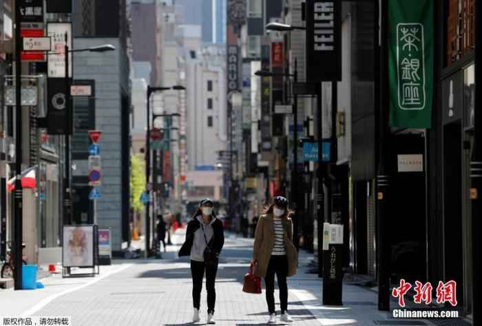 当地时间4月25日,日本东京,戴口罩的女士走过空无一人的购物区。 美国确诊病例已近百万例 世卫称新冠大流行远未结束
